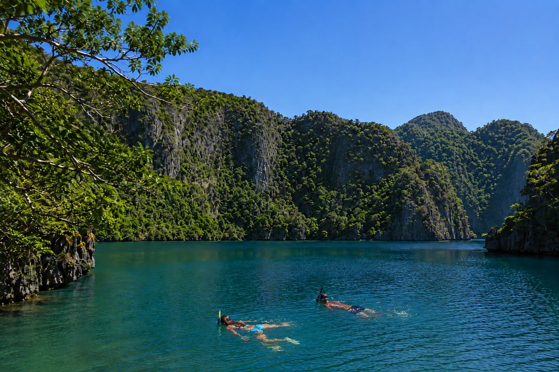 Tourists snorkeling in the crystal-clear waters of Barracuda Lake during an island adventure with El Nido Tours