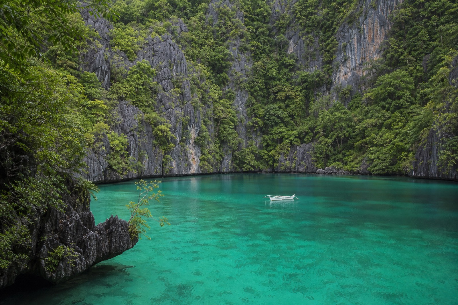 Split view contrasting El Nido's limestone lagoons with Boracay's long white-sand beach