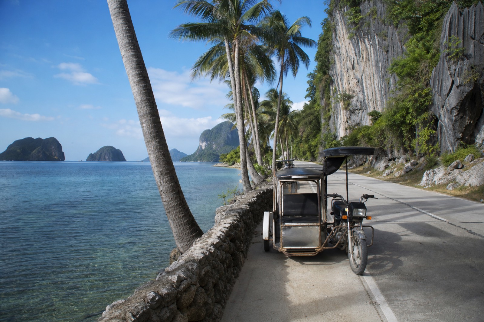 A viewpoint over Bacuit Bay from the jagged limestone Taraw Cliff above El Nido town at golden hour