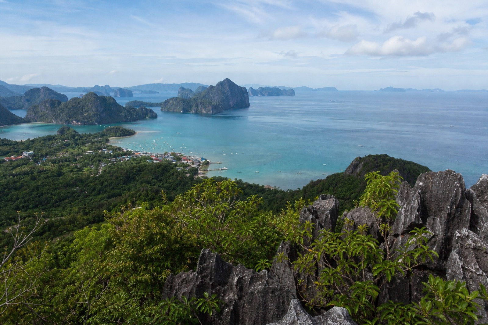 View over Bacuit Bay from the top of Taraw Cliff in El Nido, with limestone islands scattered across turquoise water below