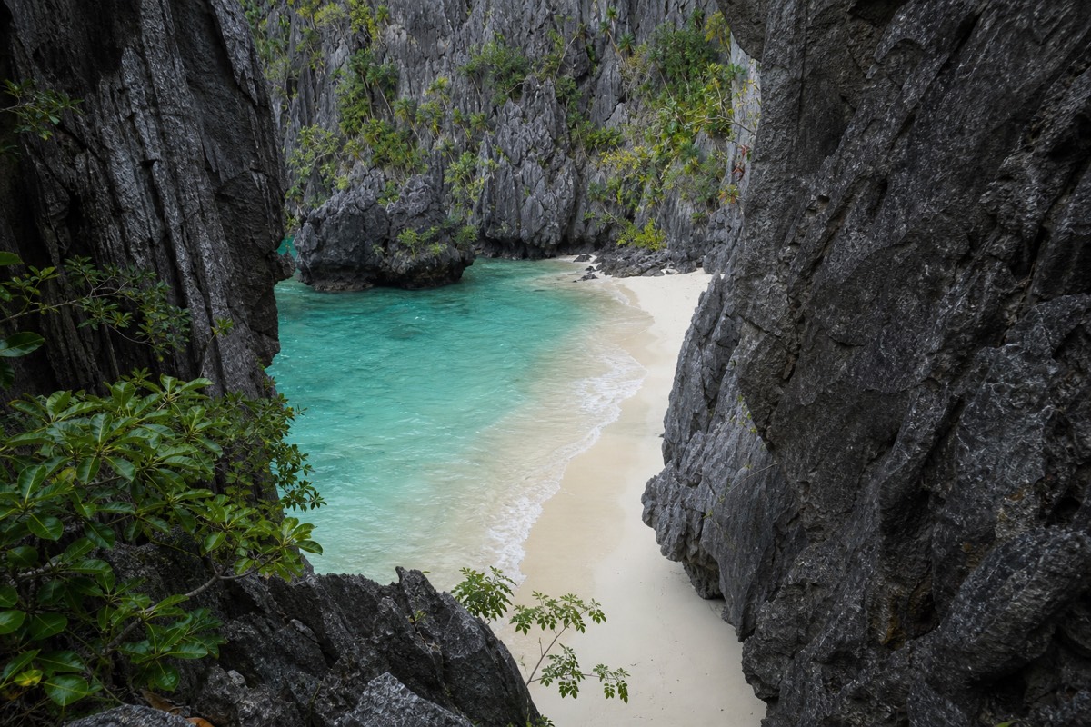 A hidden beach reached through a gap in the rock